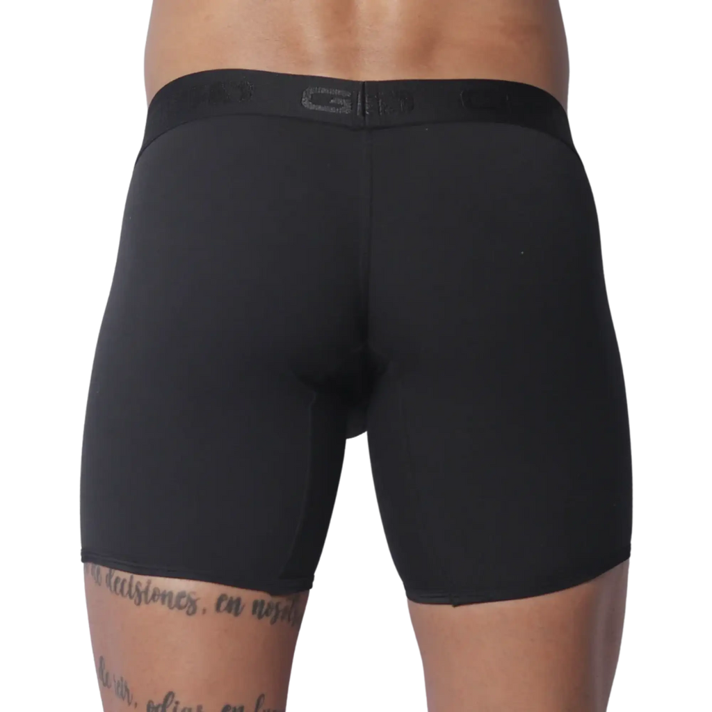 Solid black fitted boxer trunks with a wide, tonal branded elastic waistband.