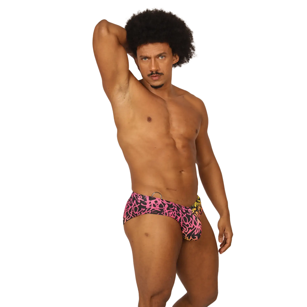 Gigo Crazy Swimbrief swim trunks in vibrant pink and black graffiti pattern with a yellow side accent for swimming