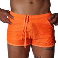 Bright orange athletic mesh shorts with a drawstring waistband and side pockets.