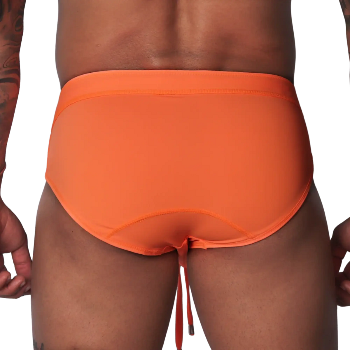 Bright orange swim brief with a wide waistband, contoured back seams, and dangling drawstring against black background.