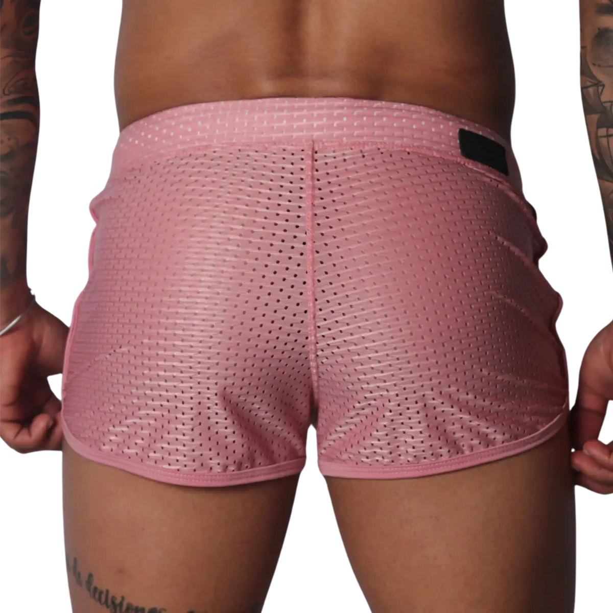 Back view of pink, breathable athletic mesh shorts with a slim fit and a dark branding patch on the waistband.