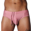 Dusty pink swim brief with a smooth center, side mesh panels, and hanging decorative drawstrings with silver tips.