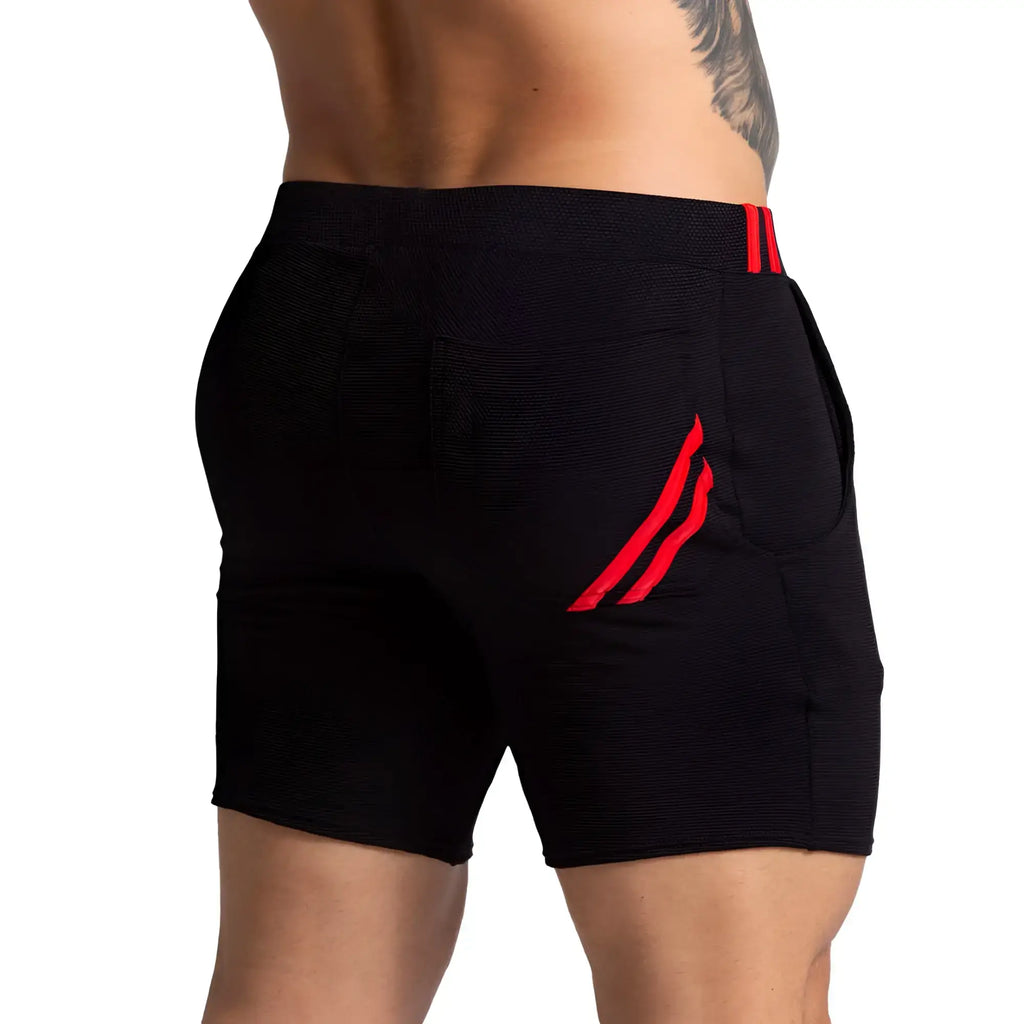 Black athletic shorts with red striped accents on waistband and side pocket gigo f fetish red short
