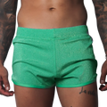 Flash green, form-fitting glittery athletic shorts with a clean hem and elastic waistband.