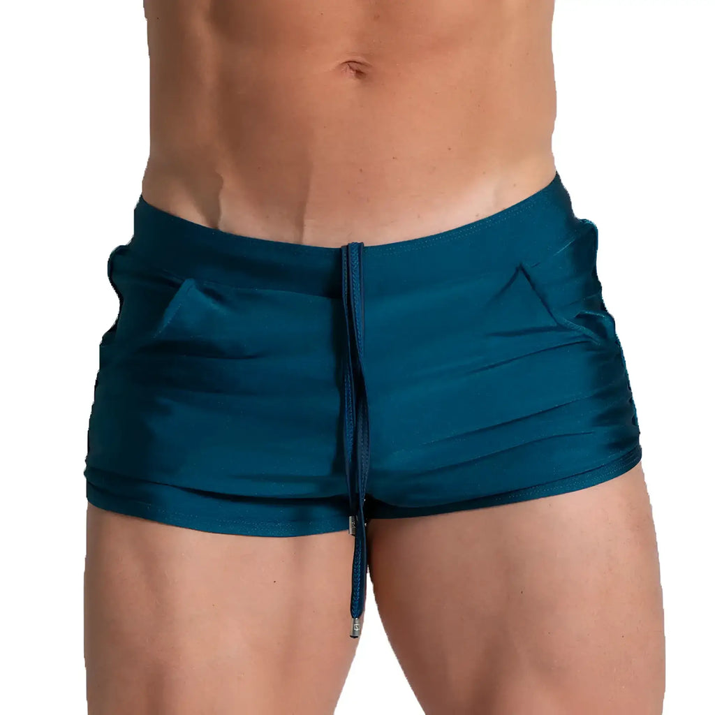 Teal satin swim trunks with drawstring waistband and side pockets from gigo flashing green beachwear collection