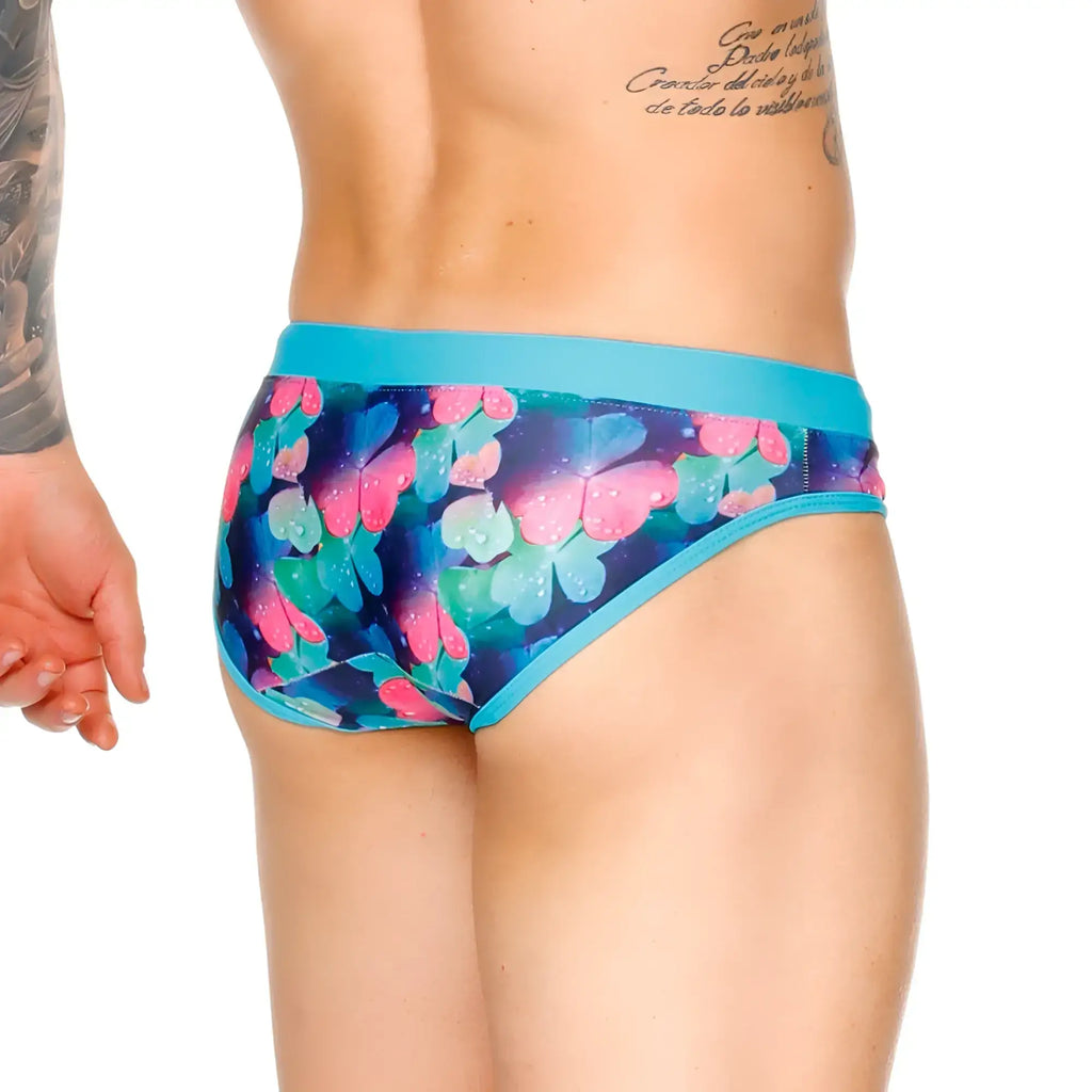 Vibrant blue and pink butterfly patterned gigo flowers swim brief with solid teal waistband for swimming and beachwear