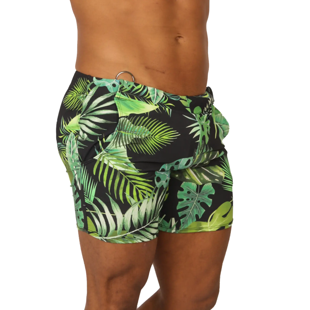 Black swim trunks with vibrant green tropical leaf pattern from Gigo Forest beachwear for summer beach use