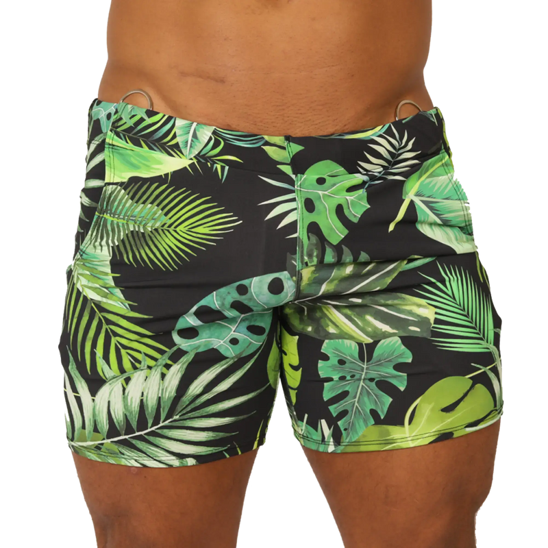 Black swim trunks with vibrant green and lime tropical leaf pattern and metallic silver waistband rings by Gigo Forest