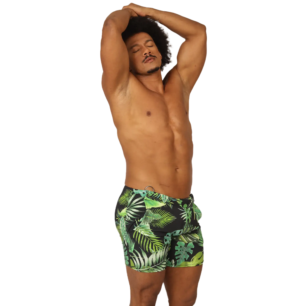 MenÃ¢â‚¬â„¢s black swim trunks with vibrant green and lime tropical leaf pattern from Gigo Forest Beachwear