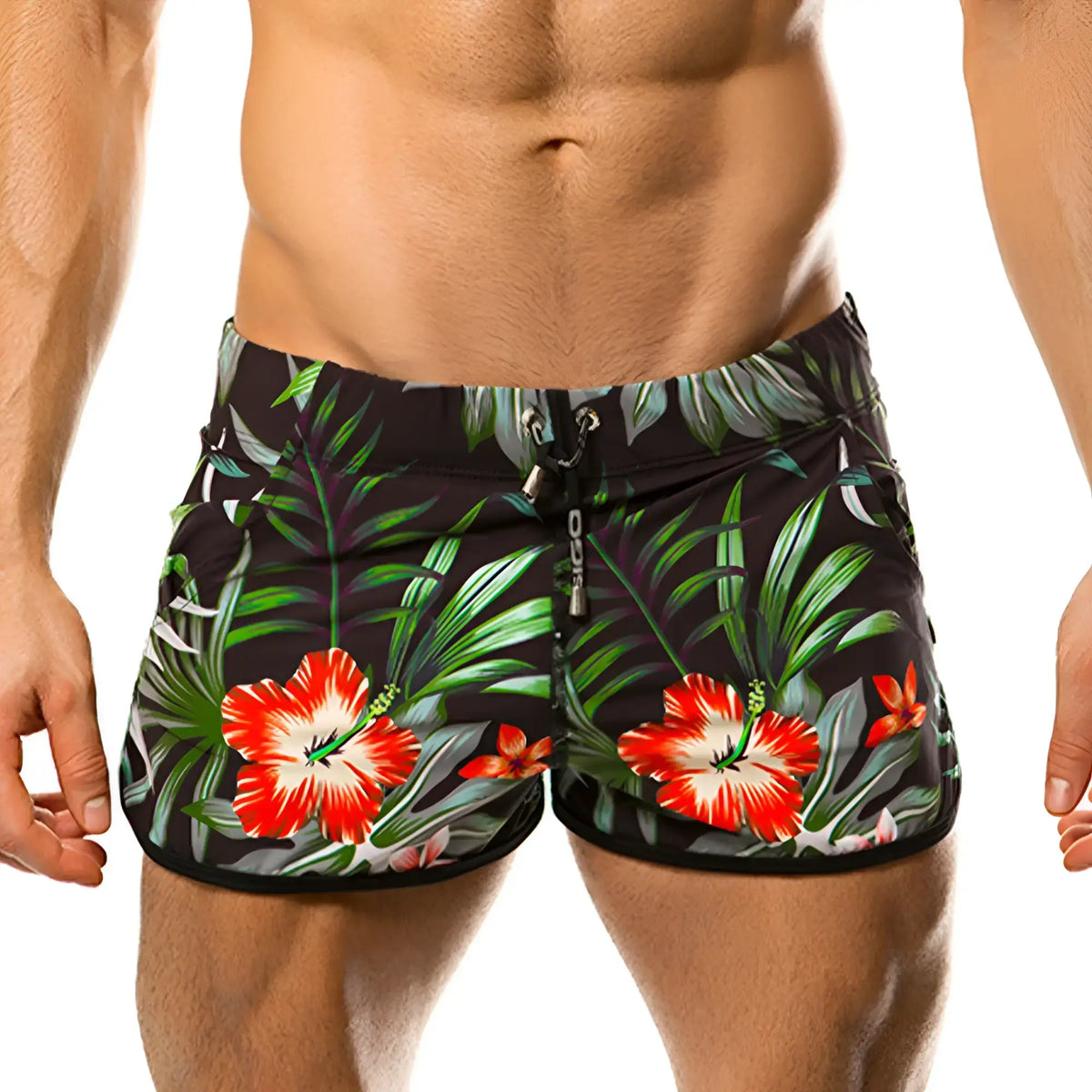 Black swim trunks from gigo garden beachwear featuring a vibrant tropical print with red hibiscus and green foliage
