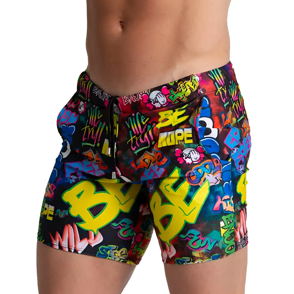 Vibrant gigo graffiti beachwear swim trunks with neon yellow green and blue graffiti pattern on black base for beachwear