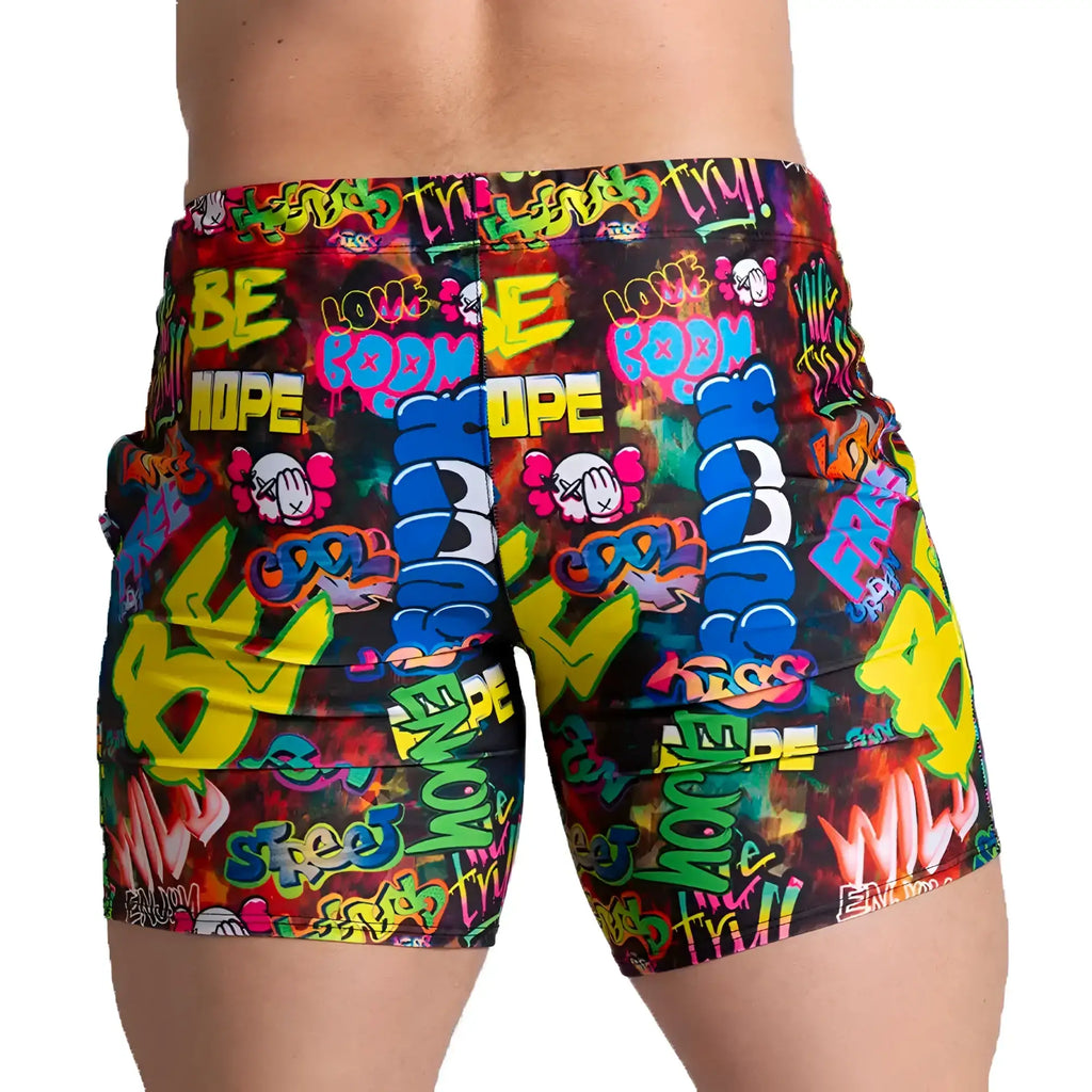 Vibrant gigo graffiti beachwear shorts with bold neon colours featuring street art typography and cartoon skulls