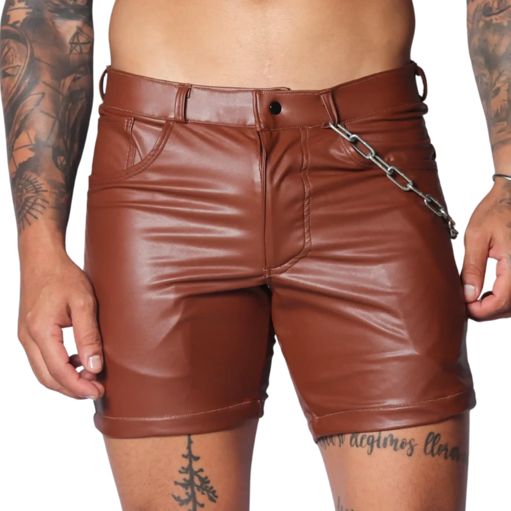 Brown faux leather fitted shorts featuring a button fly, belt loops, and a detachable silver chain detail at the hip.