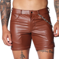 Brown faux leather fitted shorts featuring a button fly, belt loops, and a detachable silver chain detail at the hip.