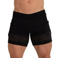 Black athletic shorts with perforated mesh panel hem featuring small white dots from gigo hole black beachwear