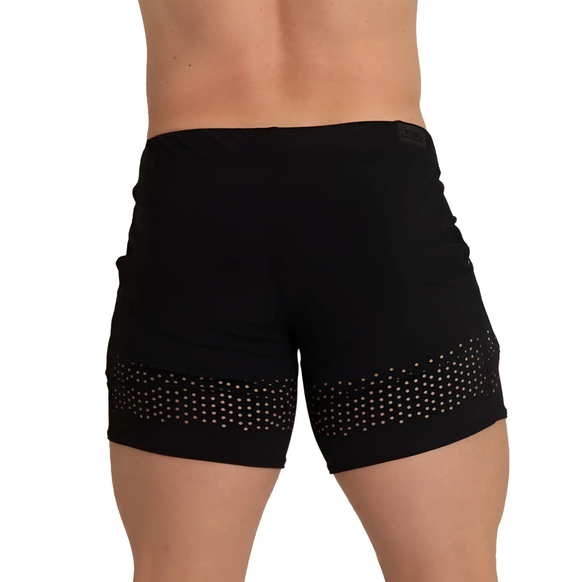Black athletic shorts with white polka dot mesh panel along the lower hem from gigo hole black beachwear collection