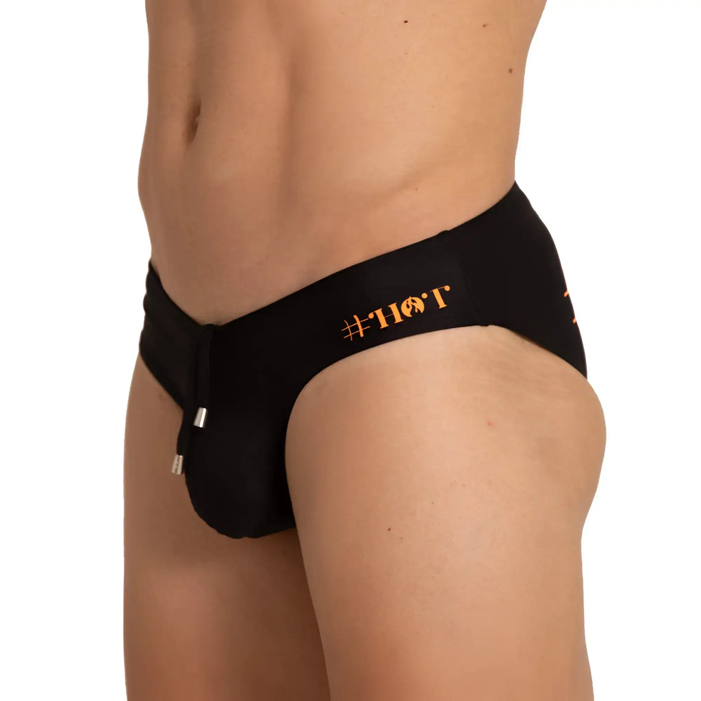 Black mens swim brief with orange hot branding on waistband from gigo designed for stylish swimwear use