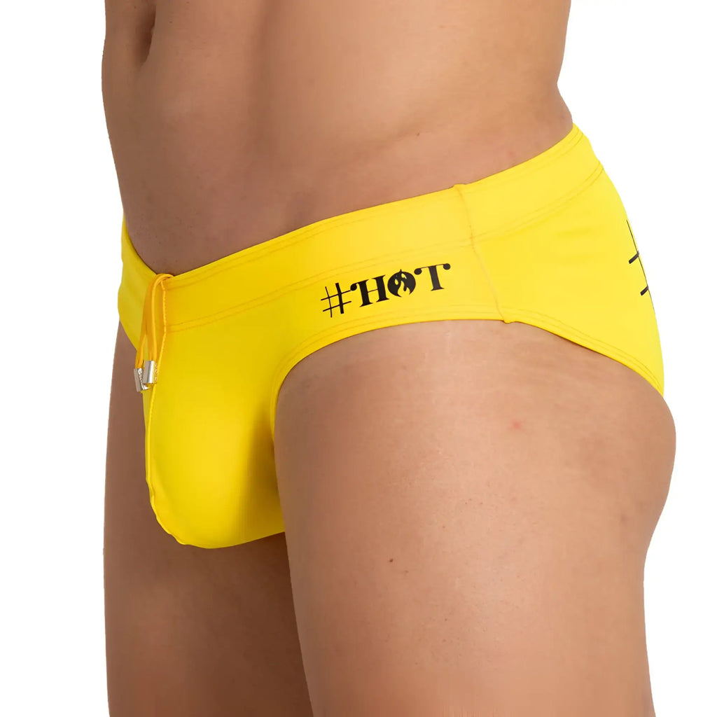 Gigo hot yellow swim brief featuring bright yellow swim trunks with black hashtag hot logo and silver drawstring hardware