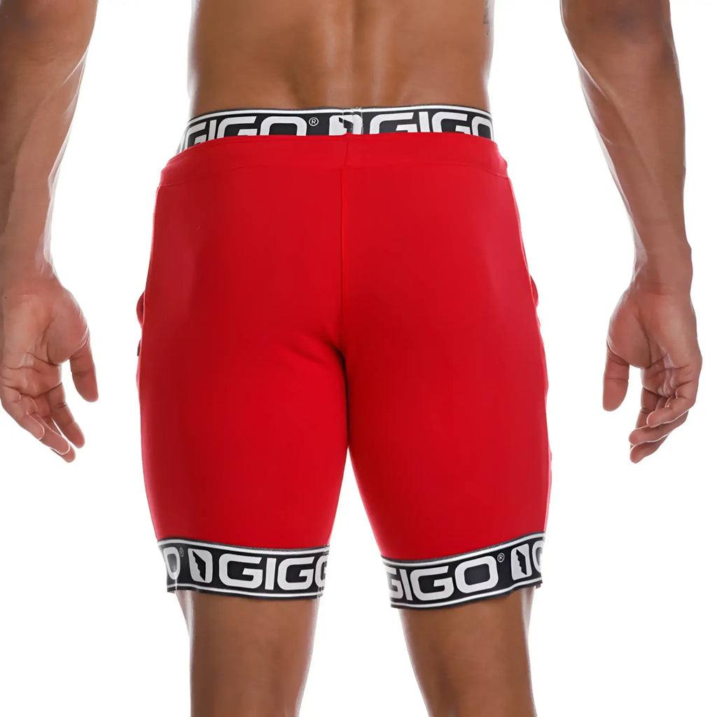 Red gigo brand athletic shorts featuring black and white logo trim at waistband and hem for active wear