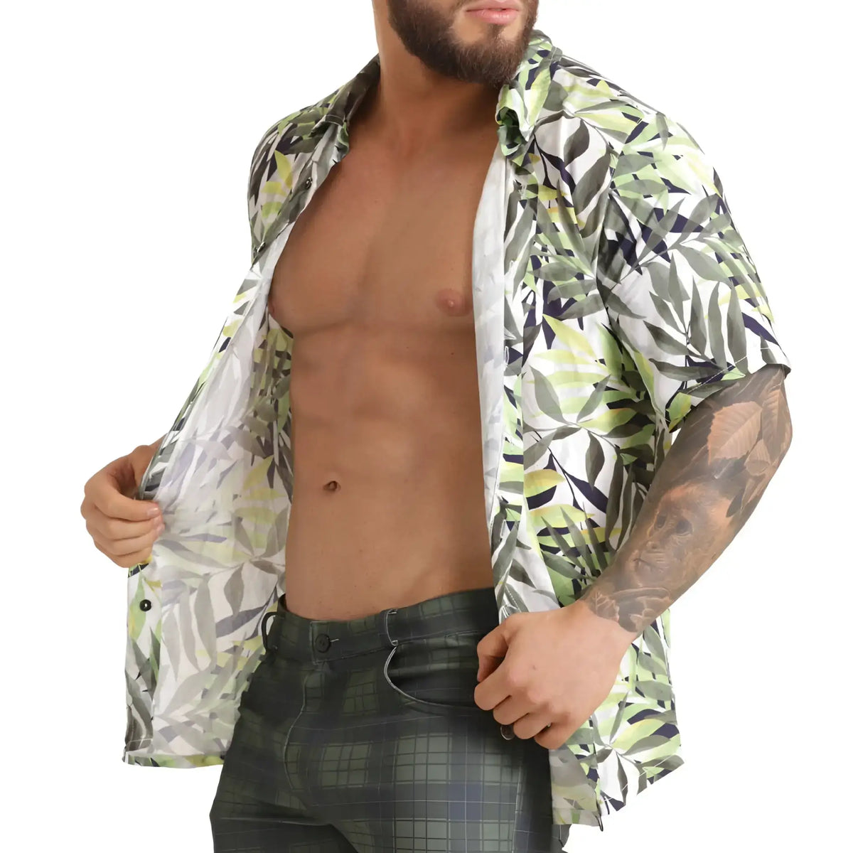 A man wearing a gigo jungle shirt short-sleeved button-up with green white and black leaf pattern