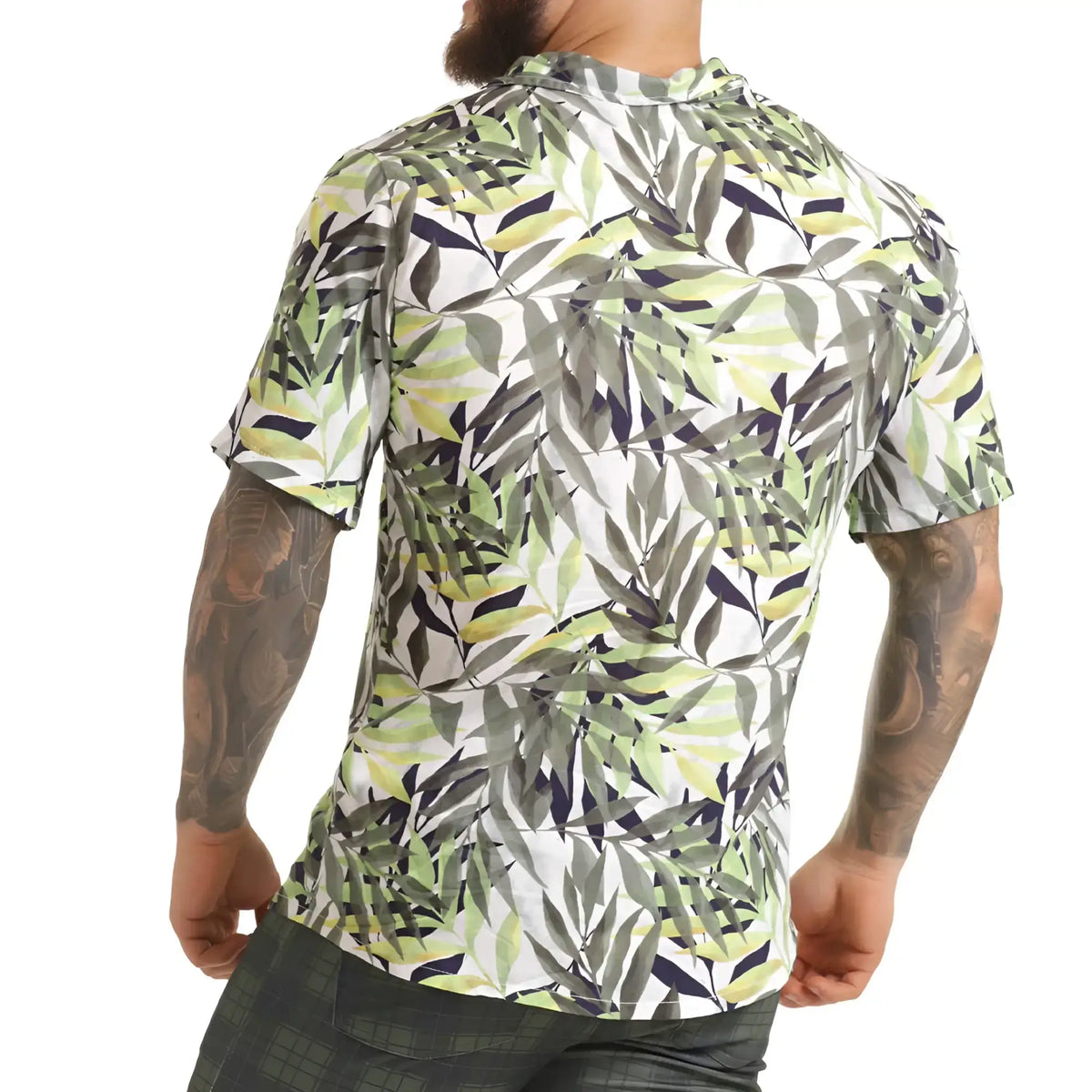 A menÃ¢â‚¬â„¢s short-sleeved button-up gigo jungle shirt with vibrant green gray and navy tropical leaf pattern on white background