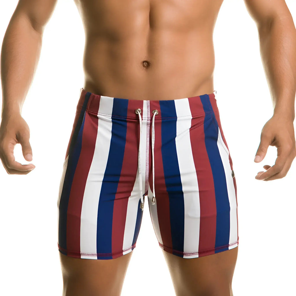 MenÃ¢â‚¬â„¢s Gigo Line Beachwear swim trunks with red white and blue vertical stripes and a drawstring waistband