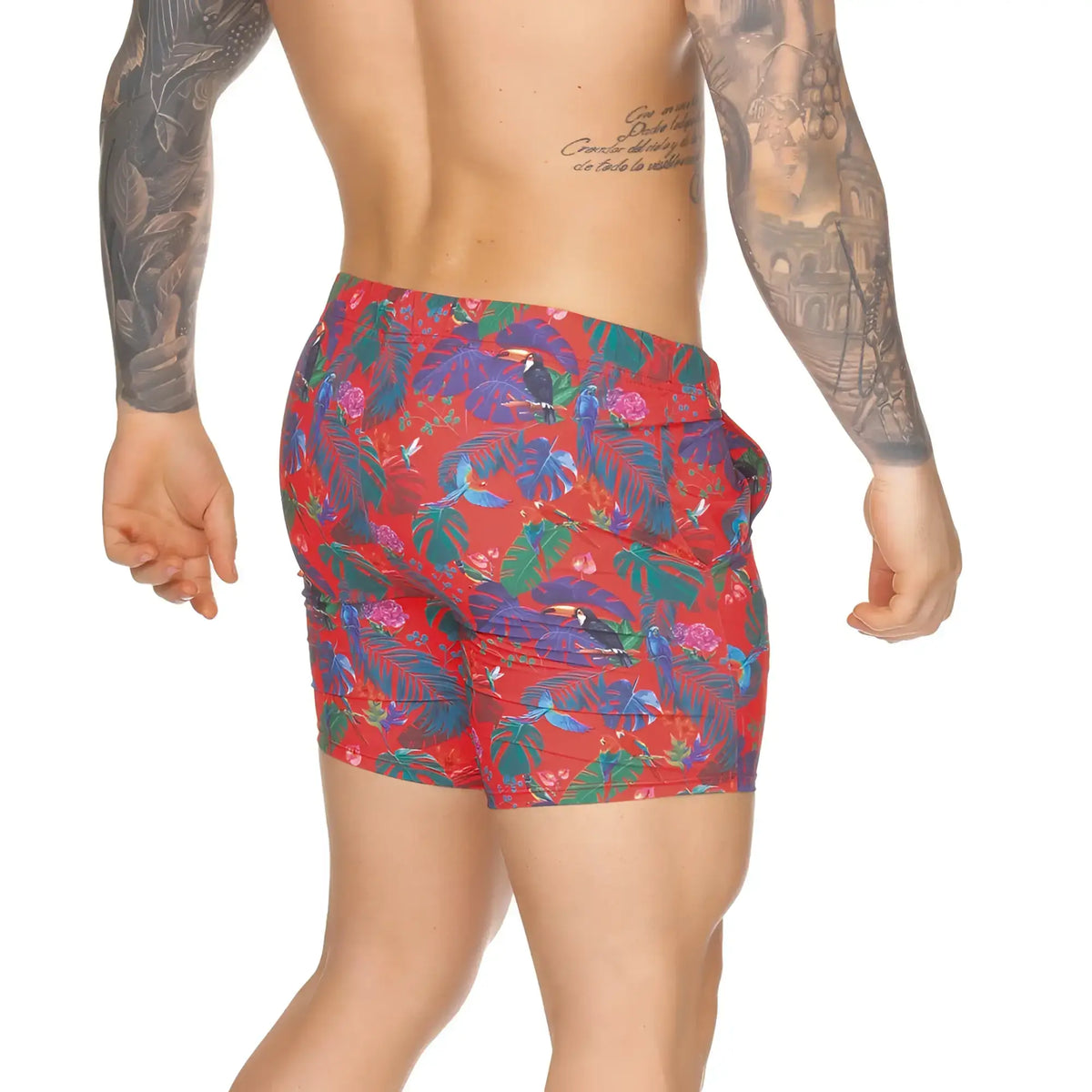 Gigo Macaws red beachwear swim trunks with vibrant blue green purple tropical leaves and toucan print