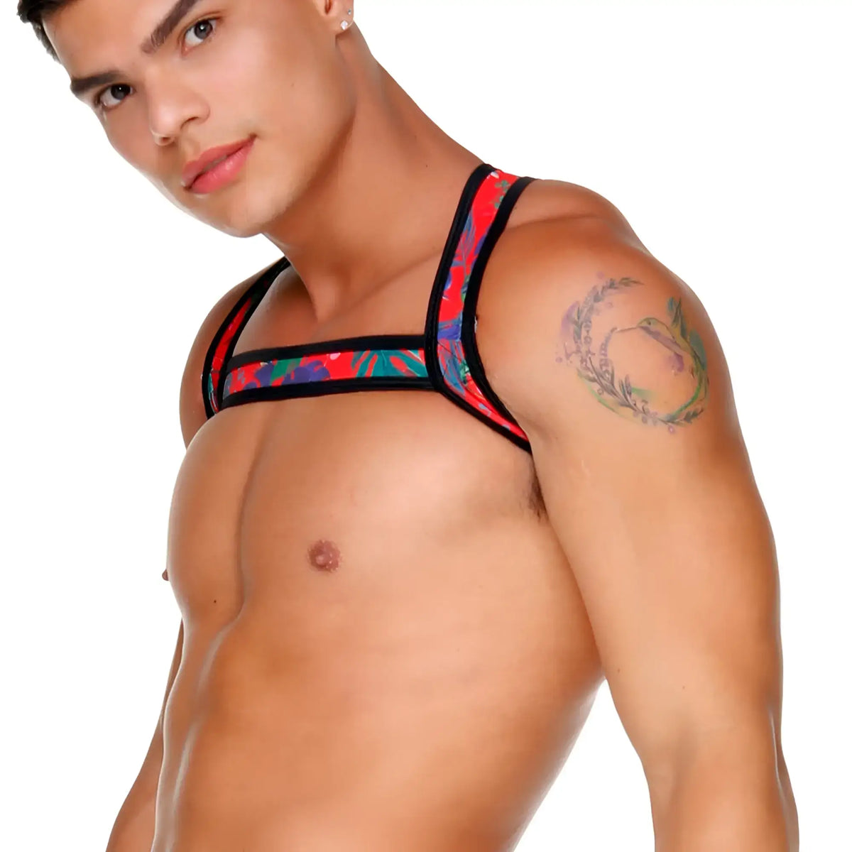 A vibrant red blue and green tropical print Gigo Macaws red harness with black trim worn by a model