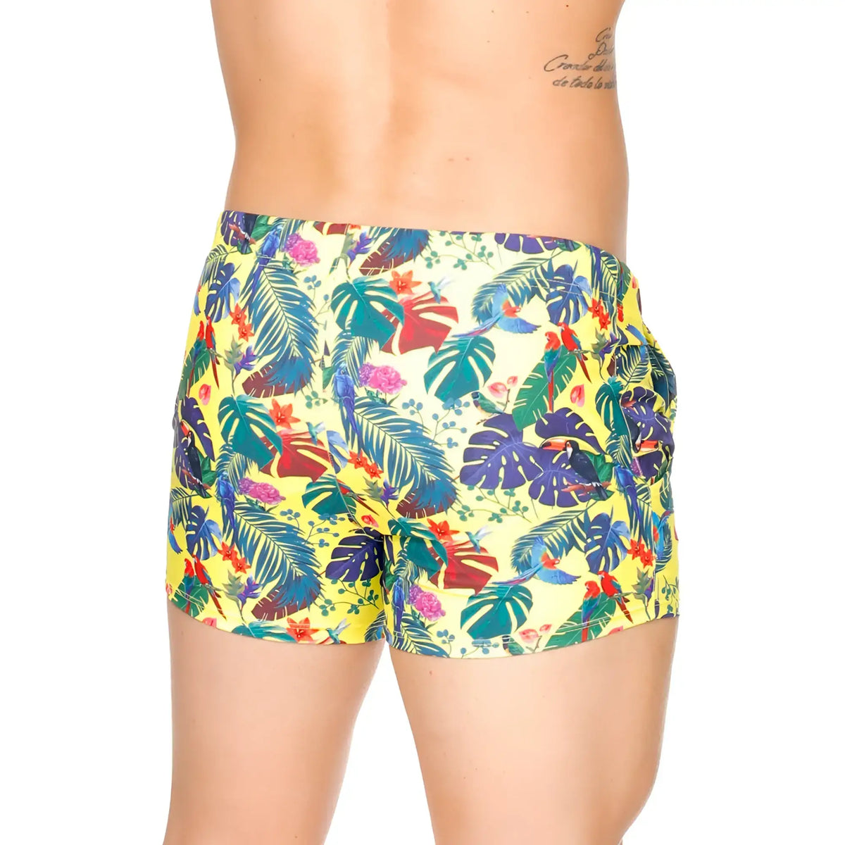 Vibrant yellow gigo macaws swim trunks with tropical blue green red and purple leaves flowers and parrots print
