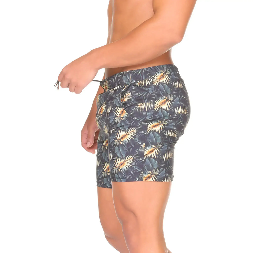 Dark gray Gigo Palms swim trunks with vibrant gold and teal tropical leaf pattern perfect for beachwear