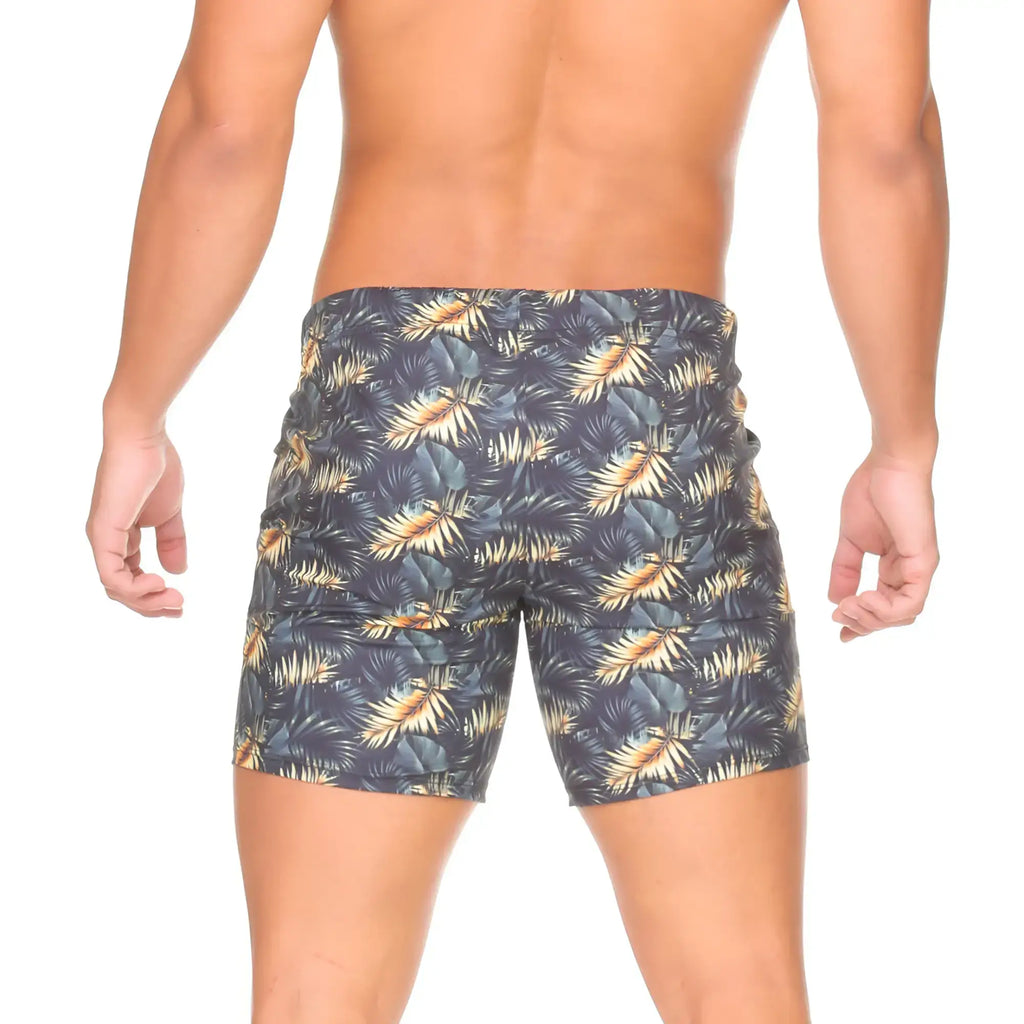 Dark blue gigo palms beachwear swim trunks with vibrant gold and green tropical leaf pattern for beach use
