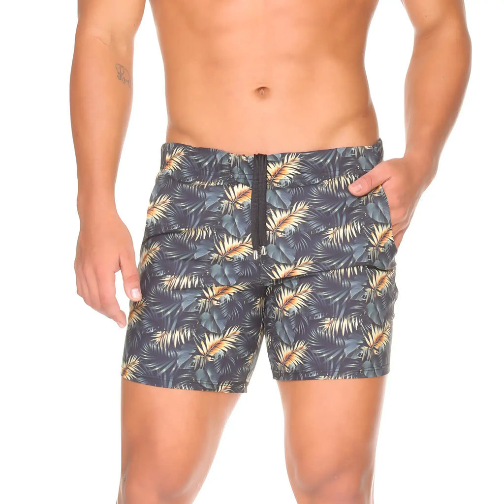 MenÃ¢â‚¬â„¢s dark gray Gigo Palms beachwear swim trunks with vibrant gold and teal tropical leaf pattern and black zipper fly