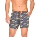 MenÃ¢â‚¬â„¢s dark gray Gigo Palms beachwear swim trunks with vibrant gold and teal tropical leaf pattern and black zipper fly