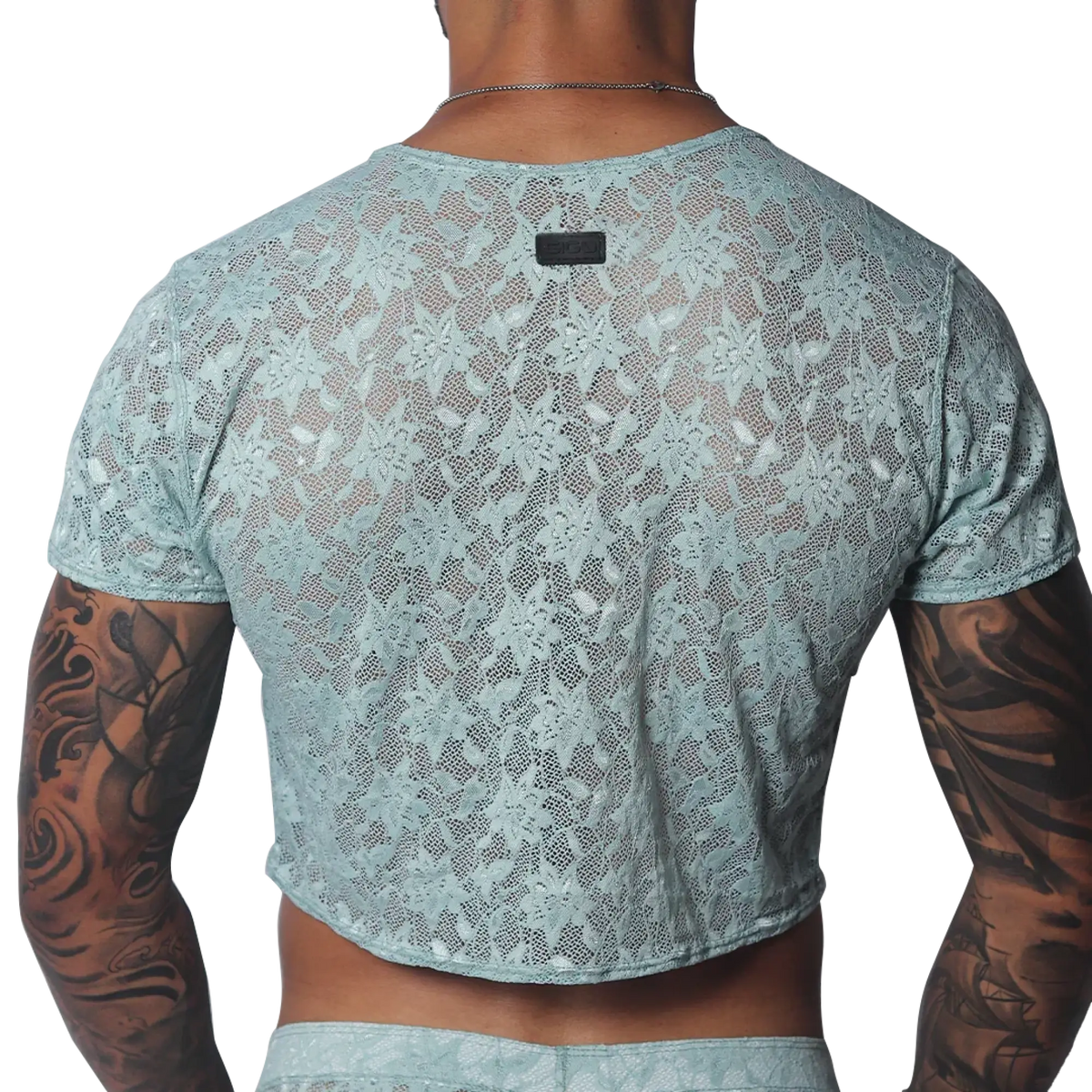 Aqua floral lace crop top with short sleeves and a small black brand tag at the back neckline.