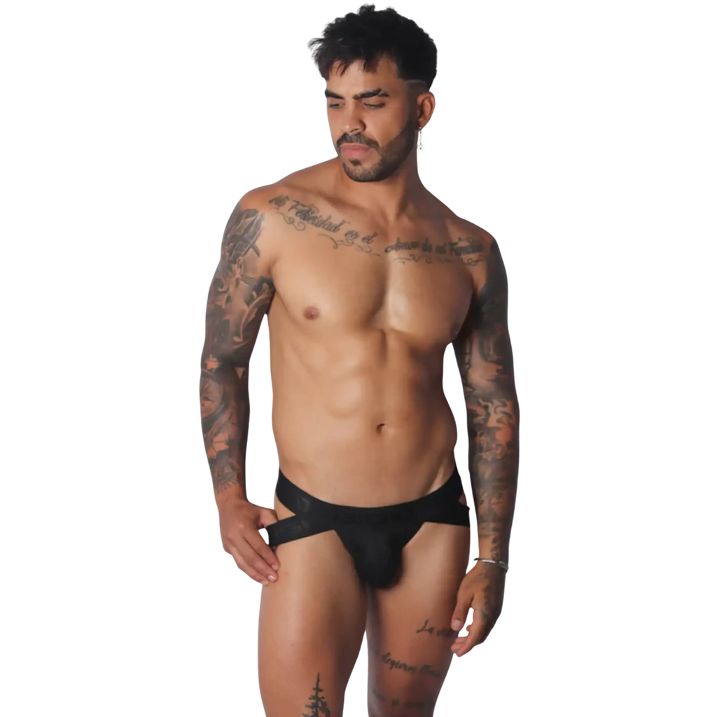 Black Gigo jockstrap featuring a wide branded elastic waistband and cutout side details on a tattooed male model.