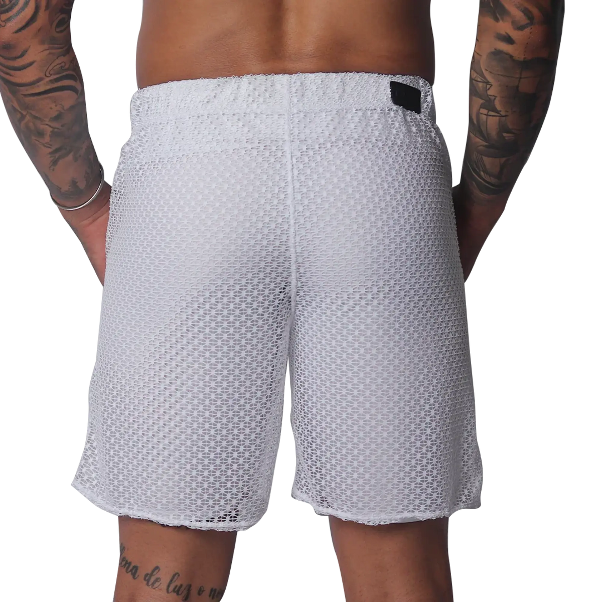 White mesh athletic shorts with an elastic waistband and a small black rectangular brand patch on the back.