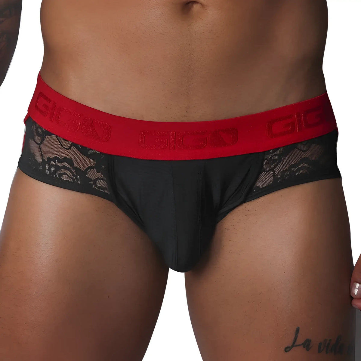 Black jock thong with floral lace side panels and a wide red elastic waistband featuring the Gigo logo.