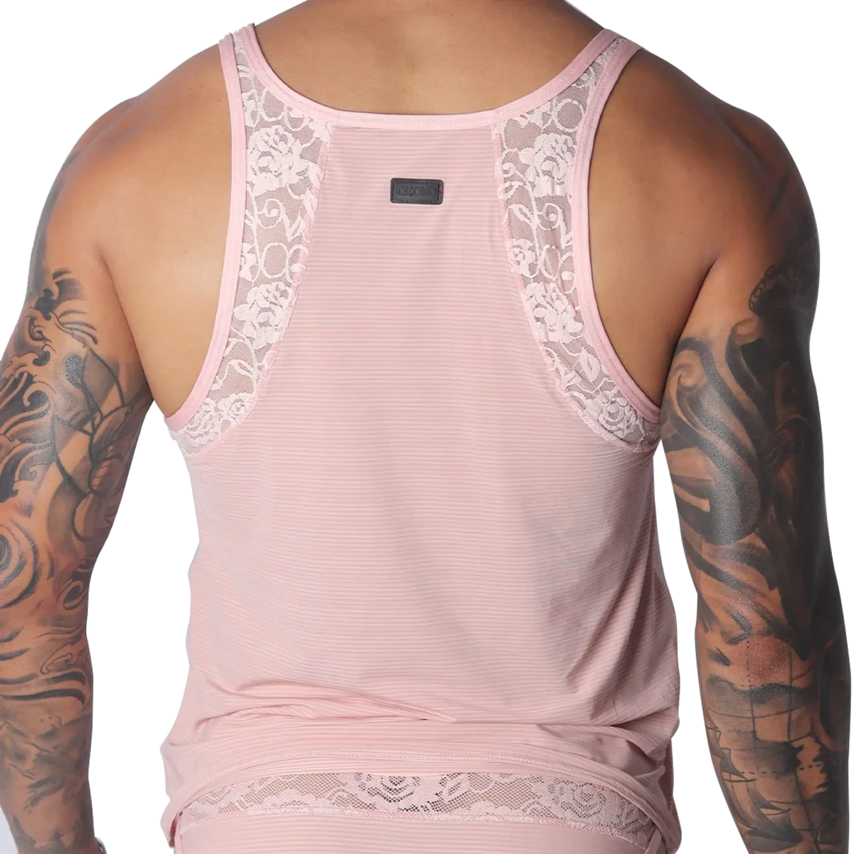 Romantic pink tank top in ribbed mesh with decorative floral lace trim along the shoulder straps and hem.