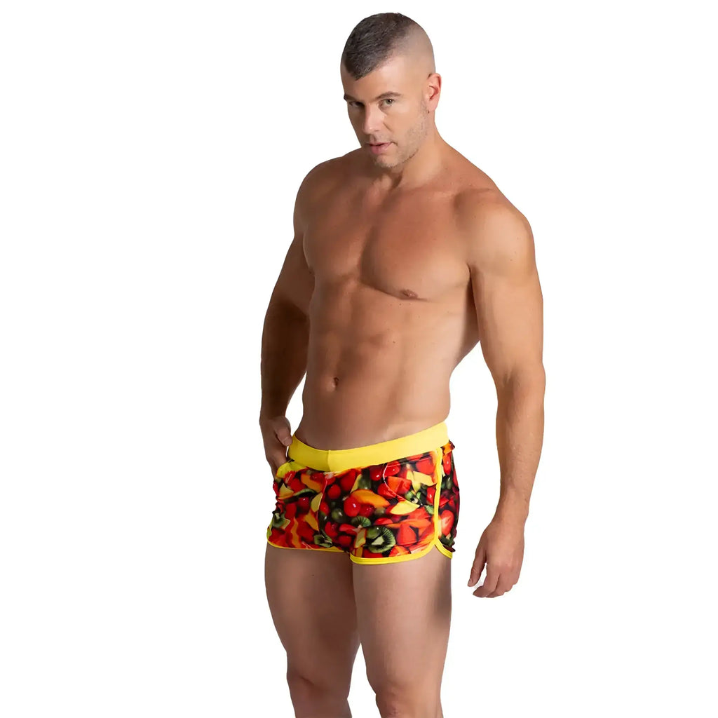 Bright yellow Gigo Salad Beachwear swim trunks with vibrant colourful fruit and vegetable print for beachwear use
