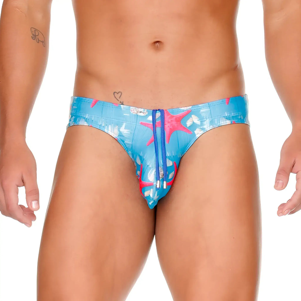 Bright blue gigo sea swim brief with vibrant pink starfish white seashell pattern and matching blue zipper detail