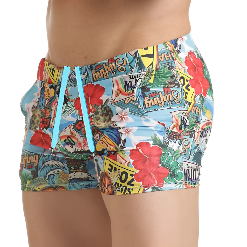 Gigo Seventies beachwear brightly coloured swim trunks with tropical collage print on light blue fabric