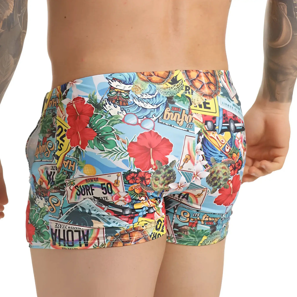 Vibrant gigo seventies beachwear swim trunks with hawaiian license plates hibiscus flowers and surf motifs on blue