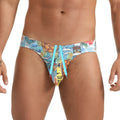 Vibrant gigo seventies swim brief with tropical print surfboards palm trees cartoon characters and light blue drawstrings