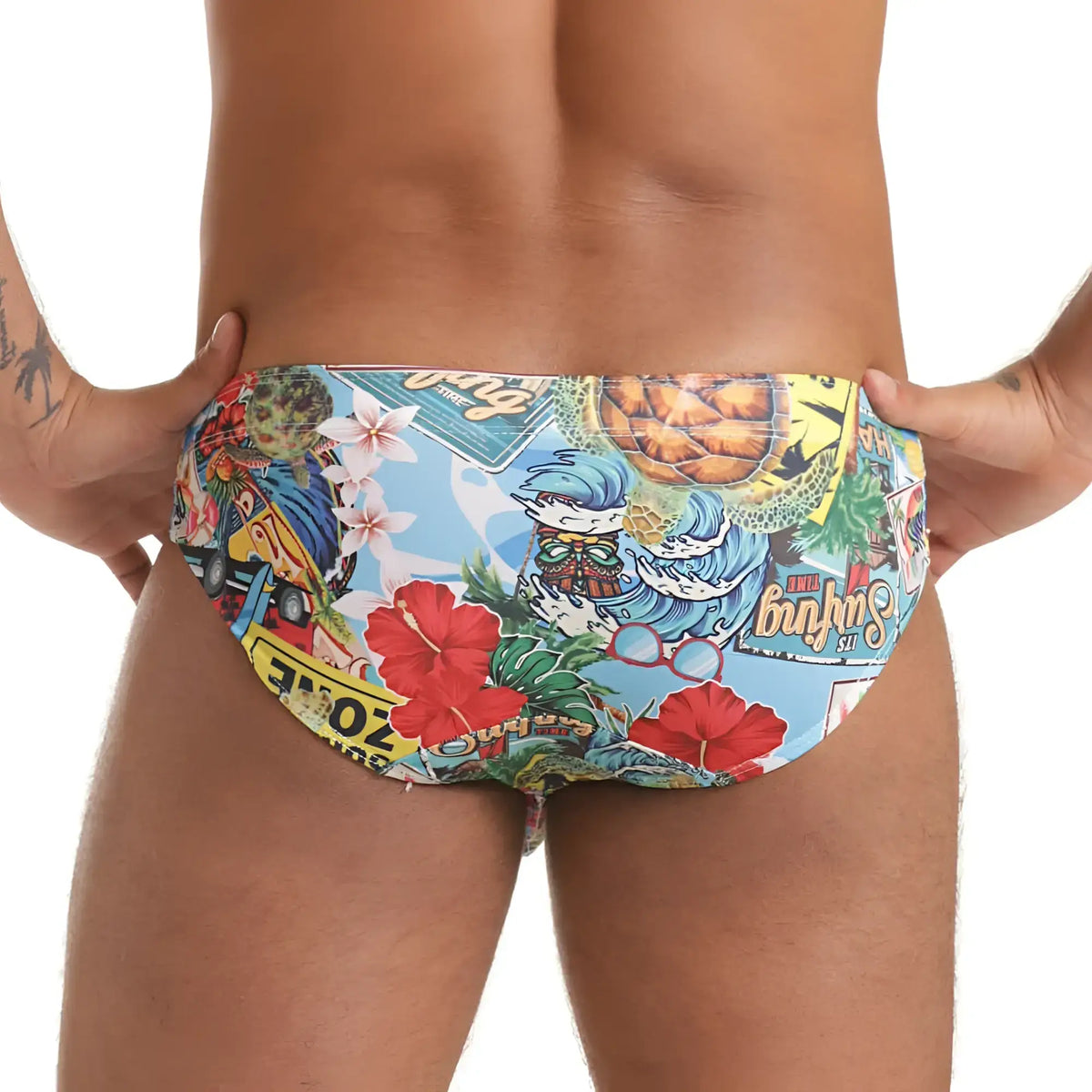 Gigo Seventies swim brief vibrant tropical swim trunks with hibiscus flowers cartoon characters on light blue background