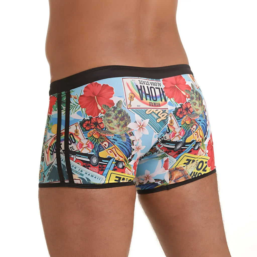 Gigo Seventies swim trunk with vibrant tropical collage of Hawaiian plates hibiscus flowers and surf on light blue