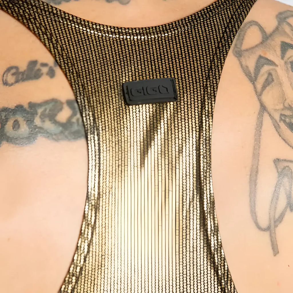 A shimmering gold mesh tank top with a black rectangular Gucci logo patch in the center called Gigo Shinese Tank