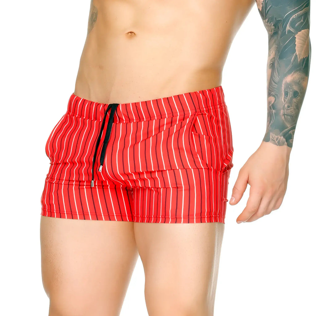 Red swim trunks with black and white vertical stripes and drawstring waistband from gigo sultan red beachwear
