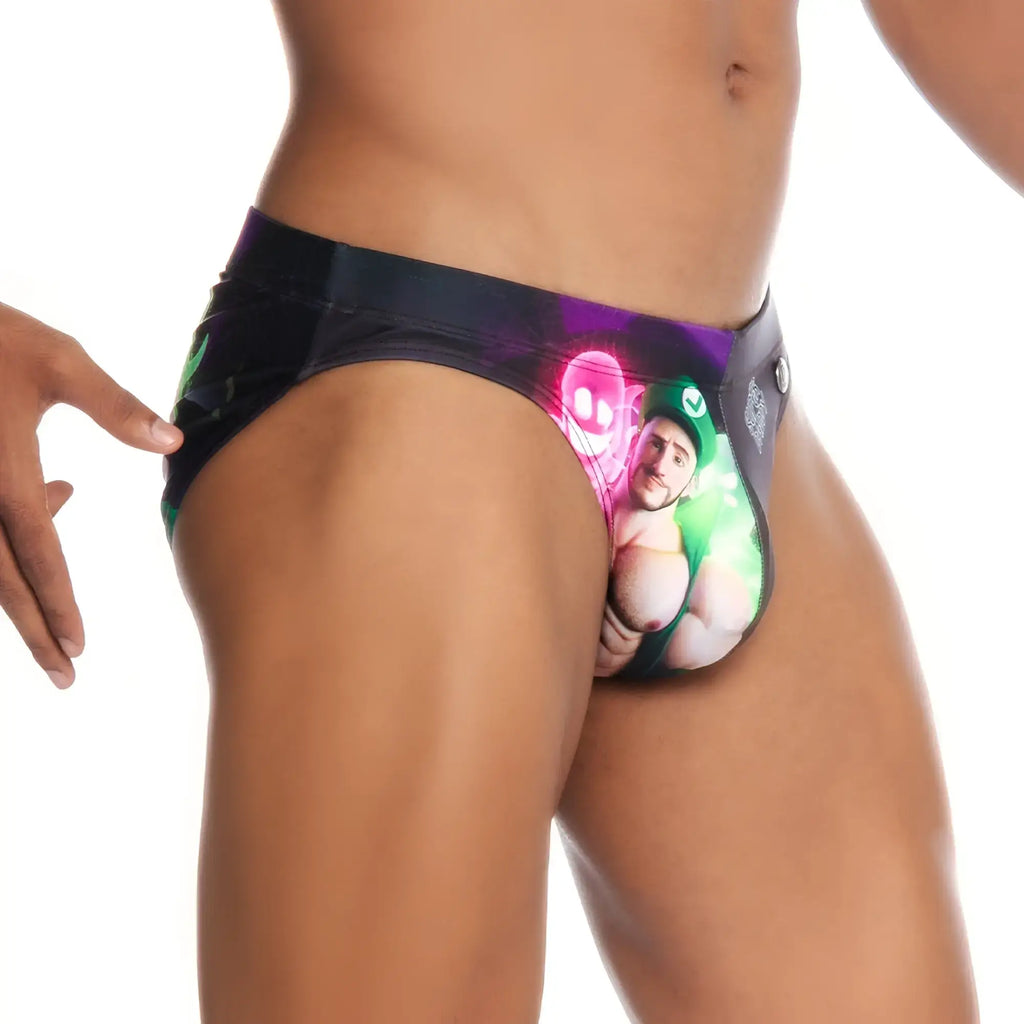Black gigo super daddy purple swim brief with vibrant graphic of man in green holding glowing pink and neon green objects