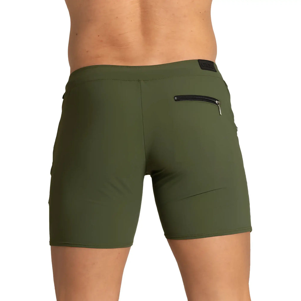 Olive green gigo tennis shorts with black zipper pocket and small brand patch on waistband for athletic use