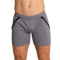 Gray athletic shorts with black zipper accents on the sides designed for training by gigo